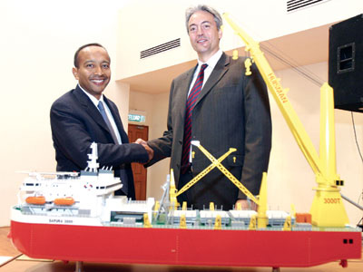 SapuraCrest executive vice chairman Shahril (left), shakes hands with Stolt Offshore COO Chabas after the joint-venture signing ceremony in Seri Kembangan, Selangor